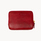 Red leather purse with a gold zipper on a white background