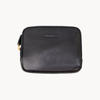 Black leather purse with gold zipper on a white background