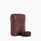 Brown leather crossbody bag with strap on a white background