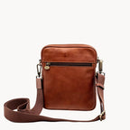 Brown leather crossbody bag on a white background
