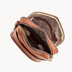 Brown leather pouch with gold zipper on a white background