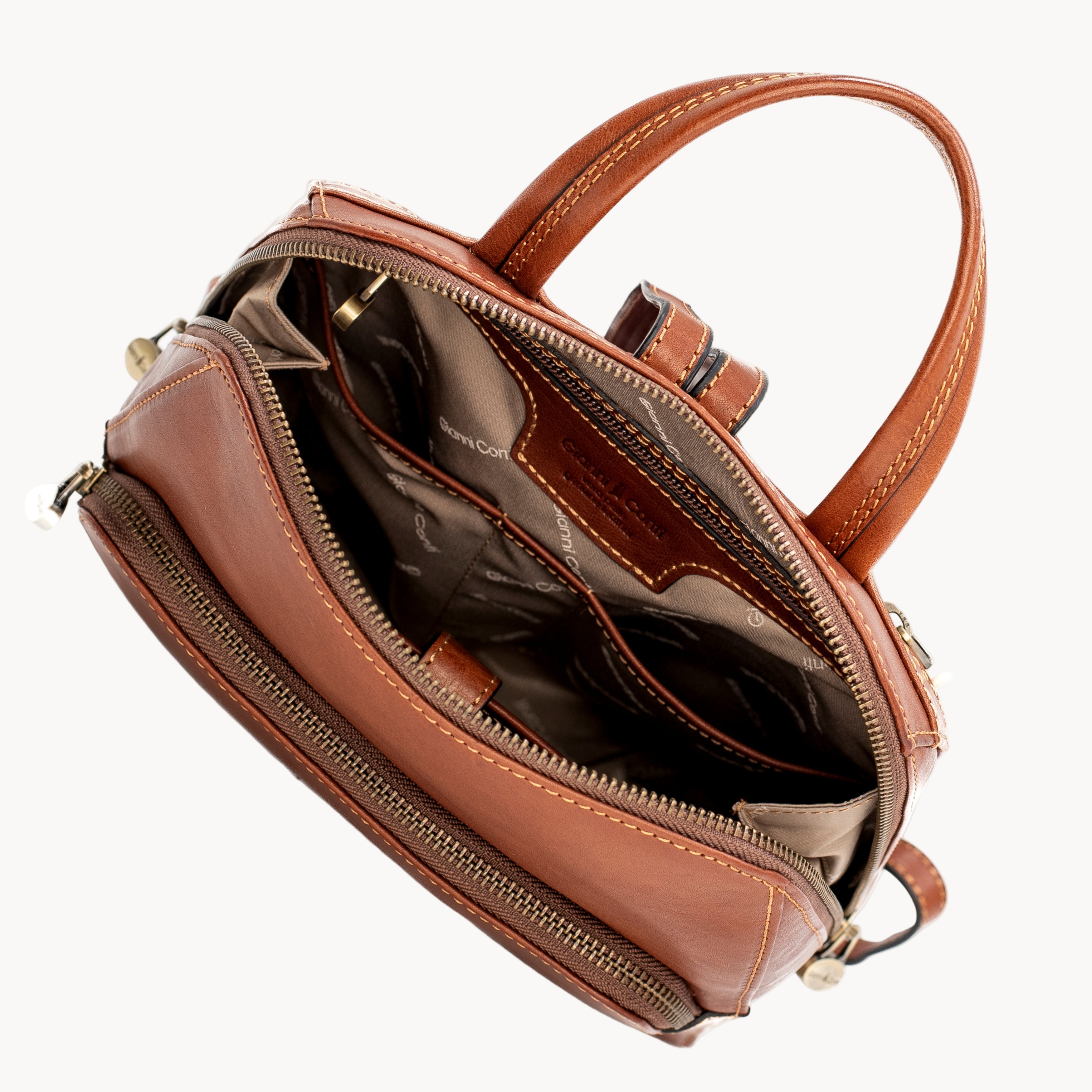 Tan leather handbag with open front compartment on a white background