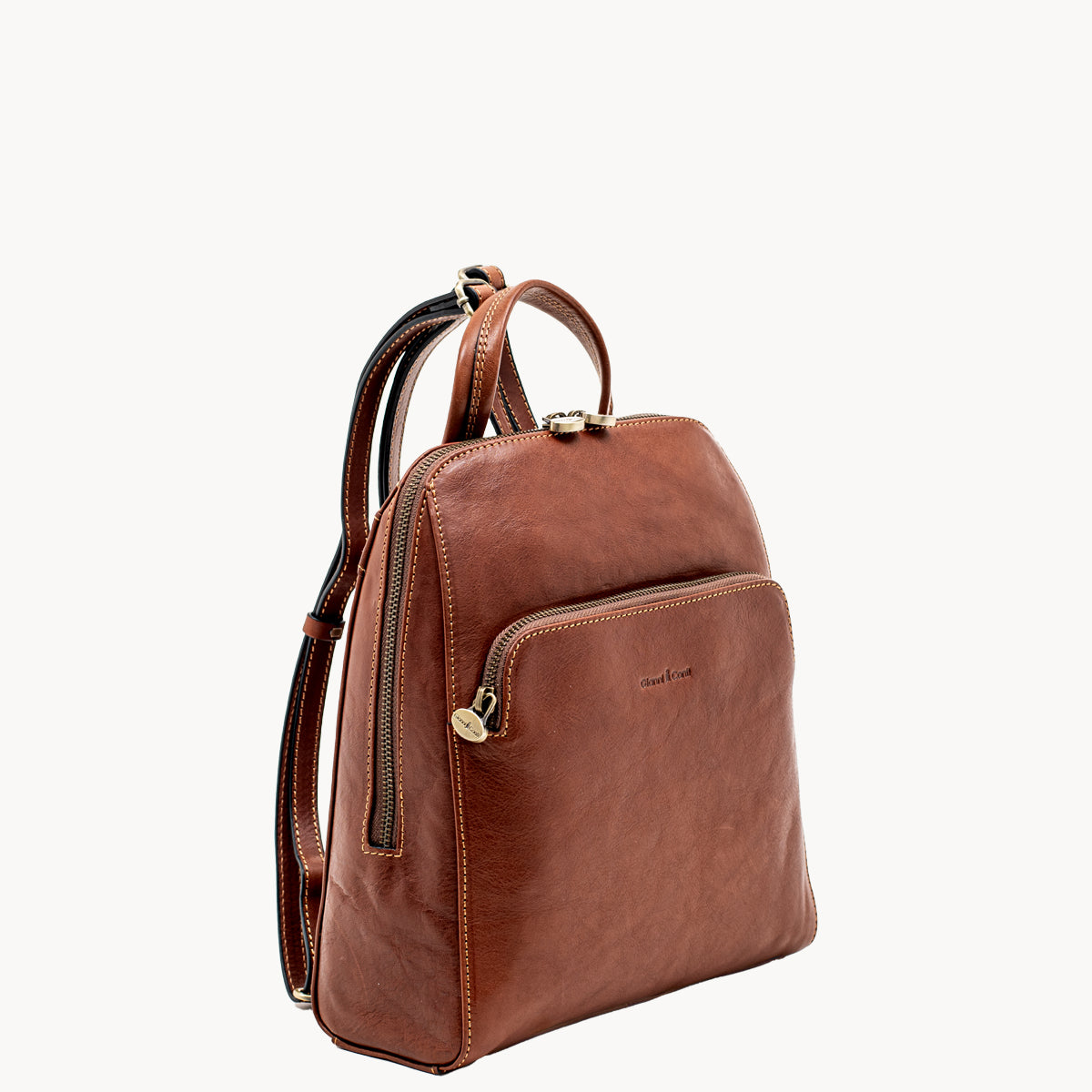 Tan leather backpack on a white background