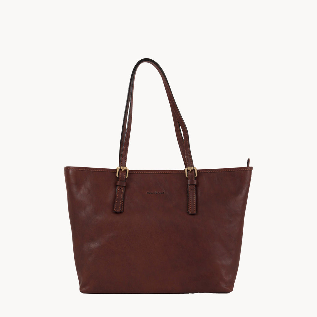 Brown leather tote bag on a white background