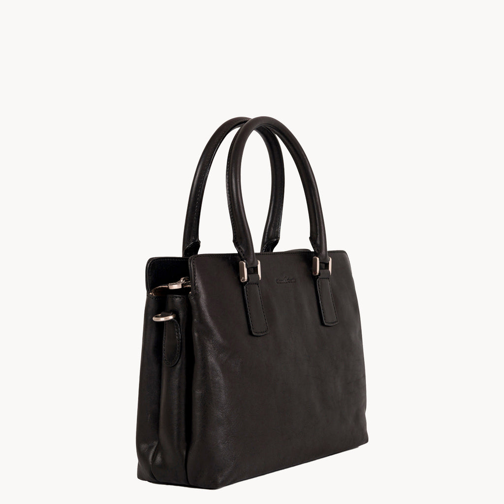 Black handbag with gold hardware on a white background