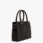 Black handbag with gold hardware on a white background