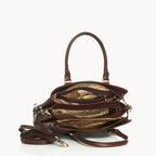 Brown leather handbag with gold hardware on a white background inside view