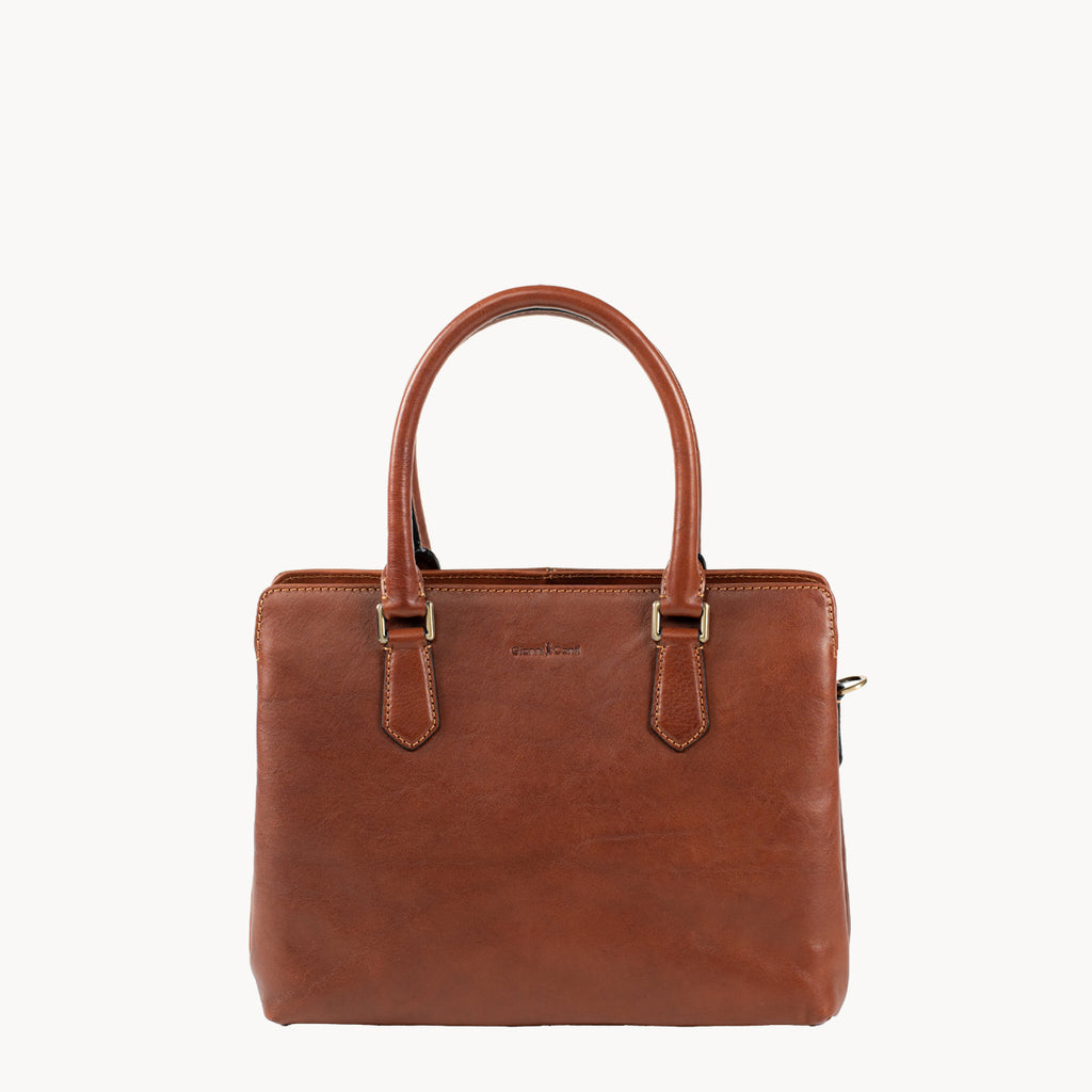 Tan leather handbag on a white background