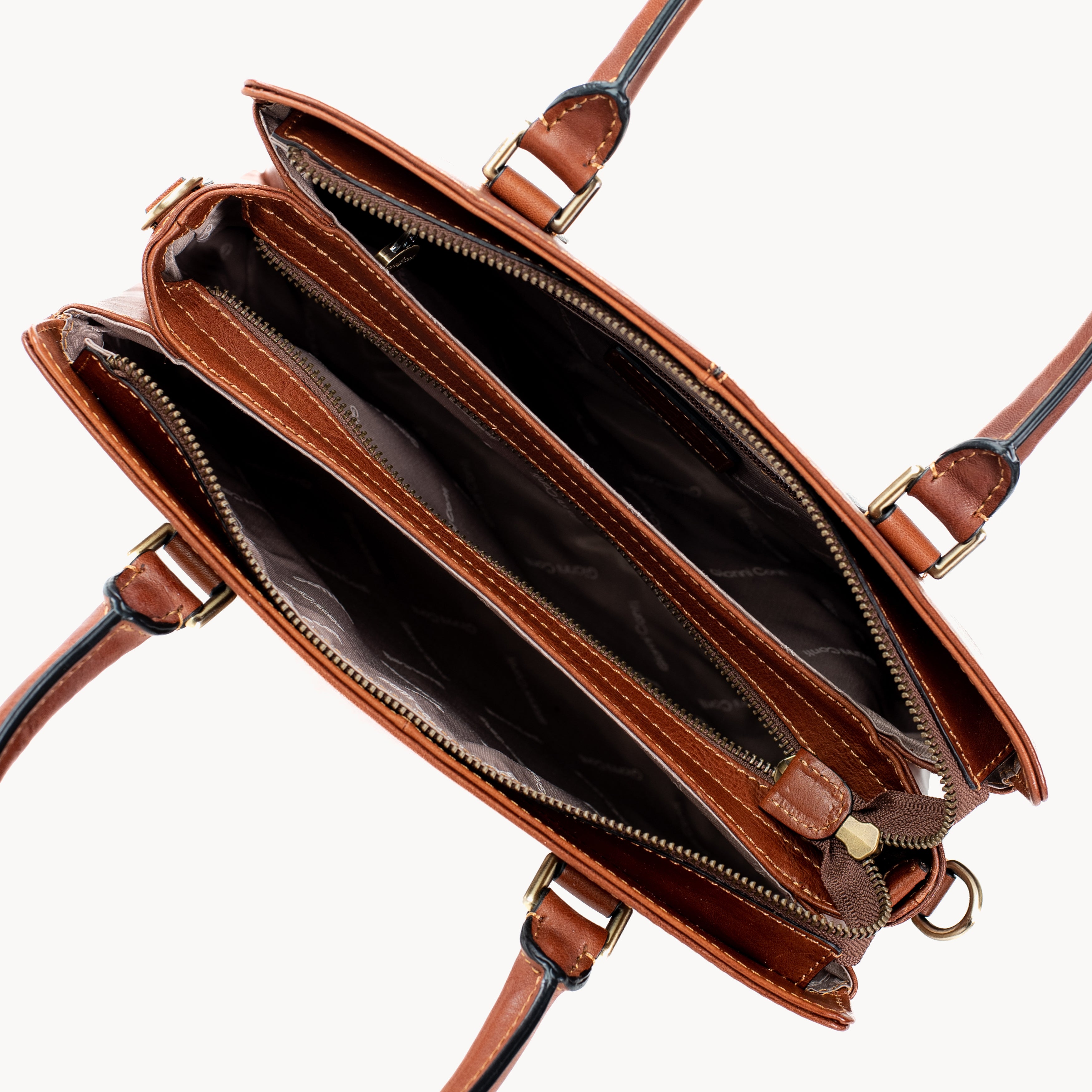 Brown leather handbag with gold hardware on a white background inside view