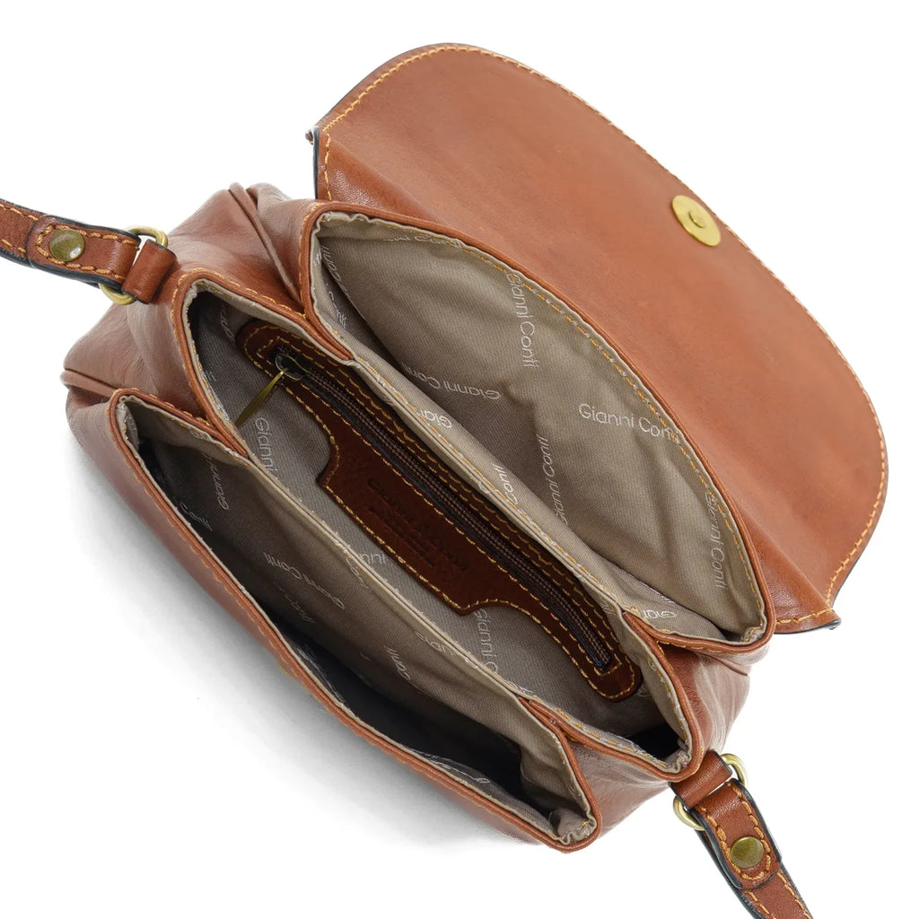 Gianni Conti Classic Leather Flap Crossbody Bag in Tan - lifestyle shot showing bag worn crossbody