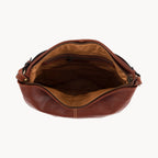 Brown leather bag with open top on a white background
