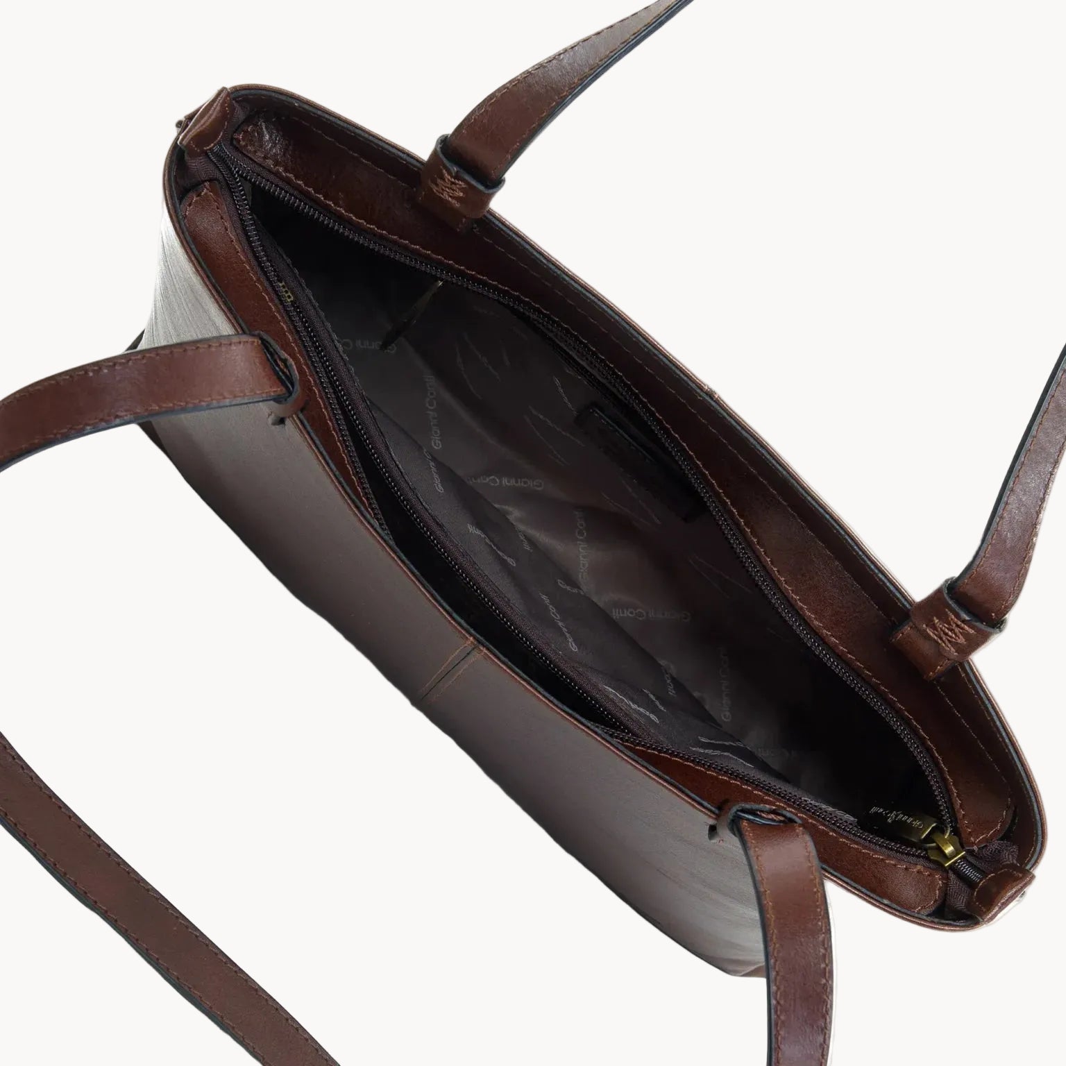 Brown leather handbag with open top on a white background