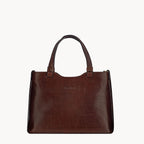 Brown leather handbag on a white background