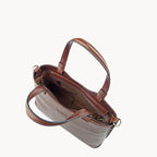 Brown leather handbag with gold hardware on a white background