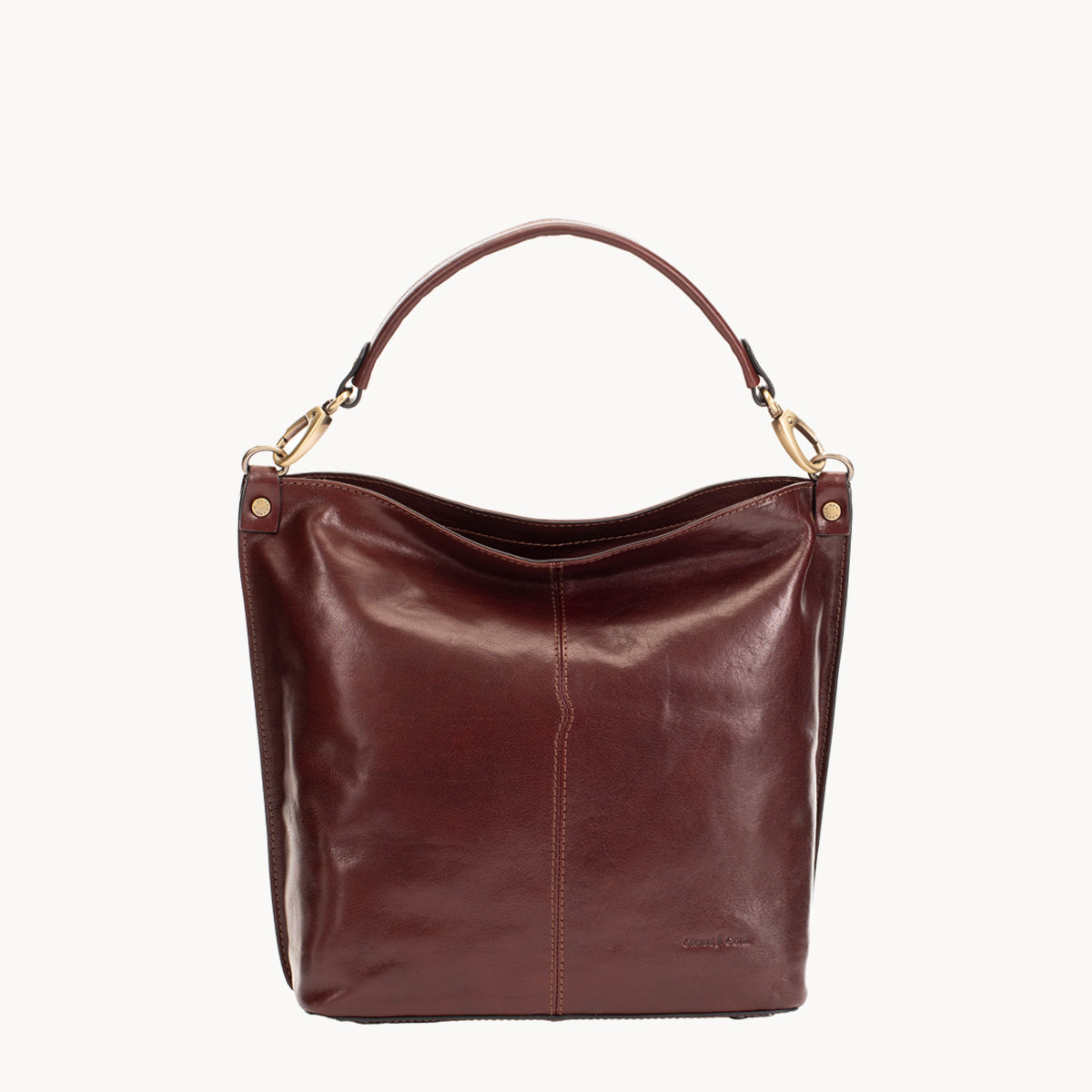 Brown leather handbag with gold hardware on a white background