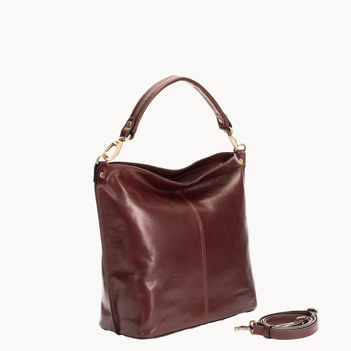 Brown leather handbag with a strap on a white background