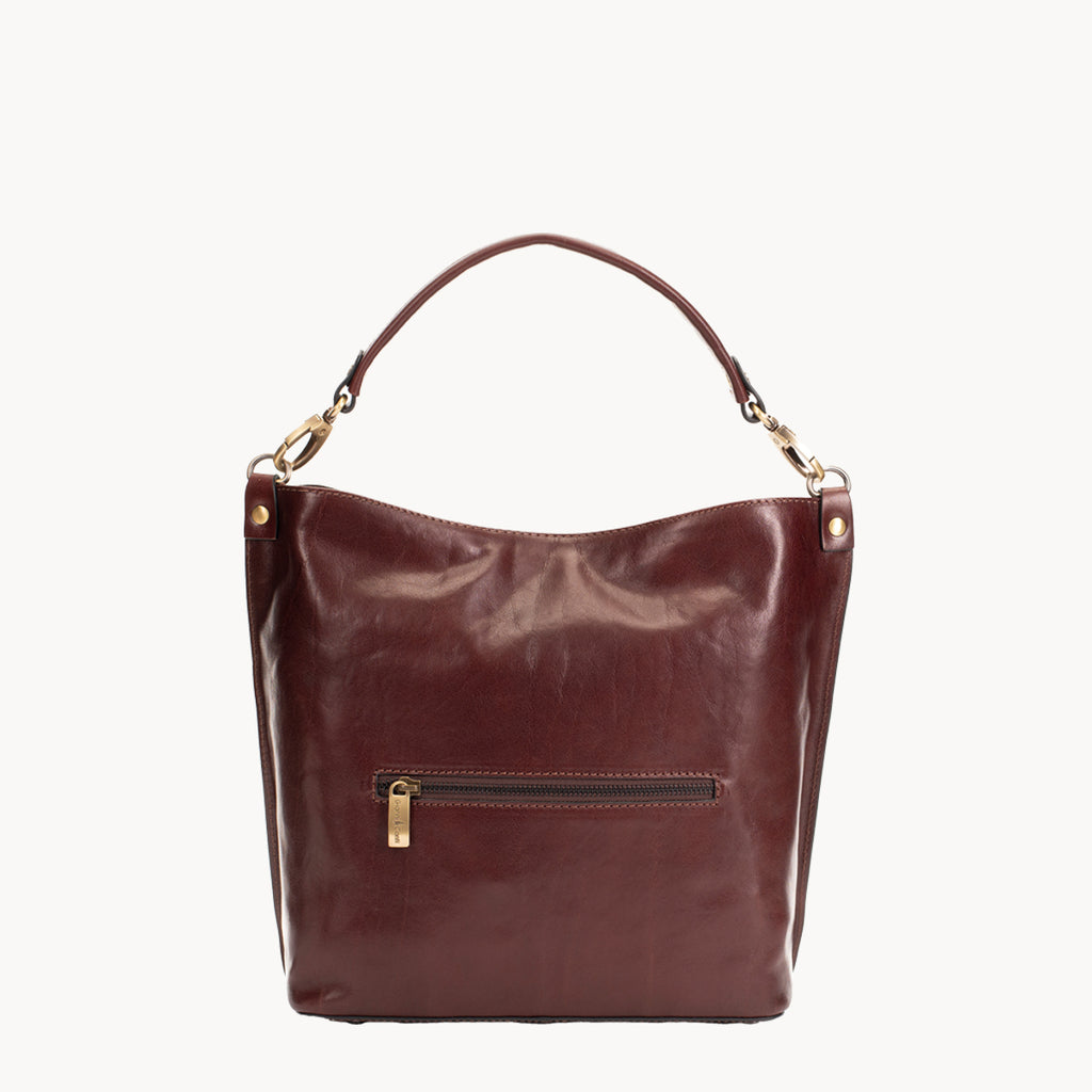 Brown leather handbag with gold accents on a white background