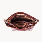 Brown leather handbag with gold accents on a white background