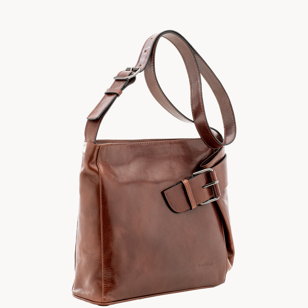 Brown leather handbag with a buckle on a white background