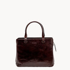 Brown leather handbag on a white background