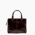 Brown leather grab bag on a white background