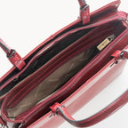 Red handbag with visible brand logo on a white background - inside view