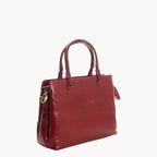 Red handbag with gold zipper on a white background