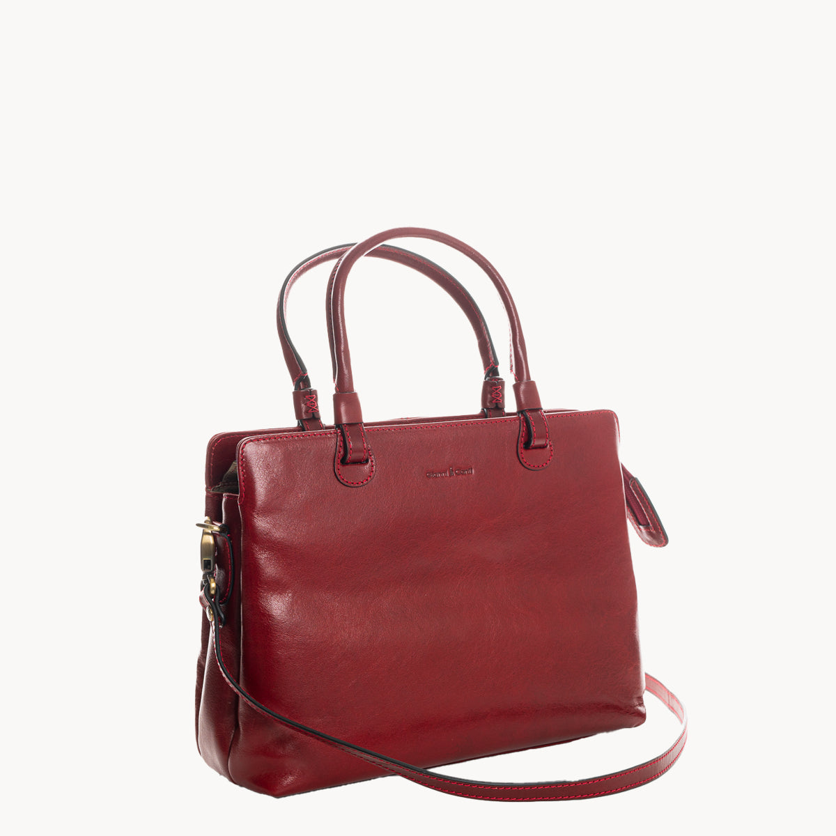 Red handbag with a strap on a white background