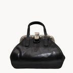 Black handbag with a silver clasp on a white background