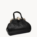 Black handbag with a metallic clasp on a white background