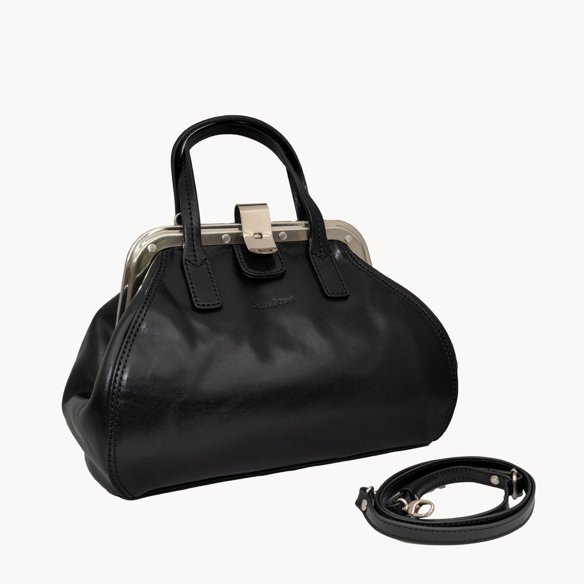 Black handbag with a strap on a white background