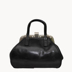 Black handbag with a metallic clasp on a white background