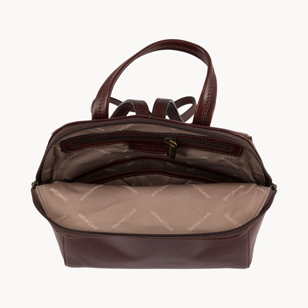 Brown leather backpack inside view with Gianni Conti jacquard lining on a white background