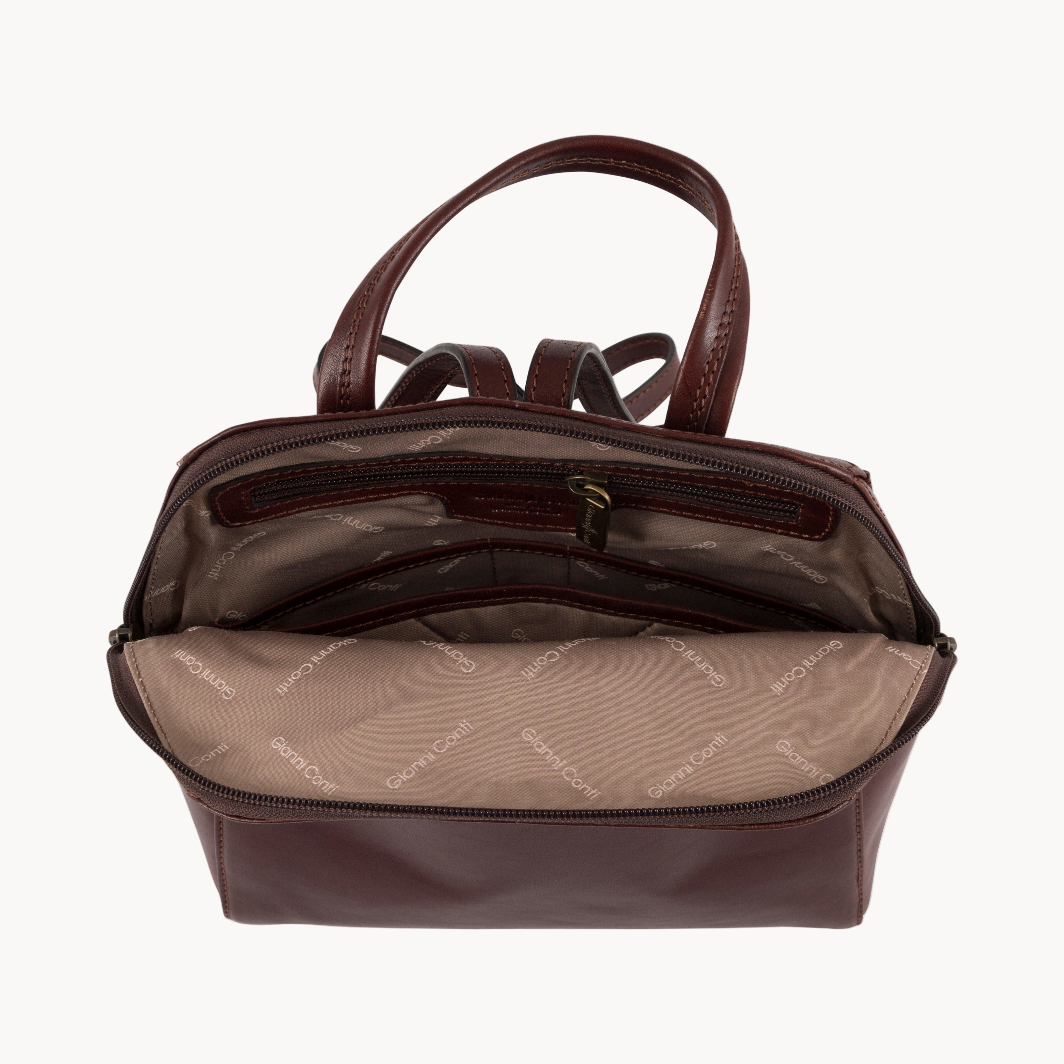 Brown leather backpack inside view with Gianni Conti jacquard lining on a white background