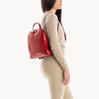 Woman wearing a red backpack on a white background