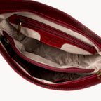 Red handbag with visible brand logo on a white background