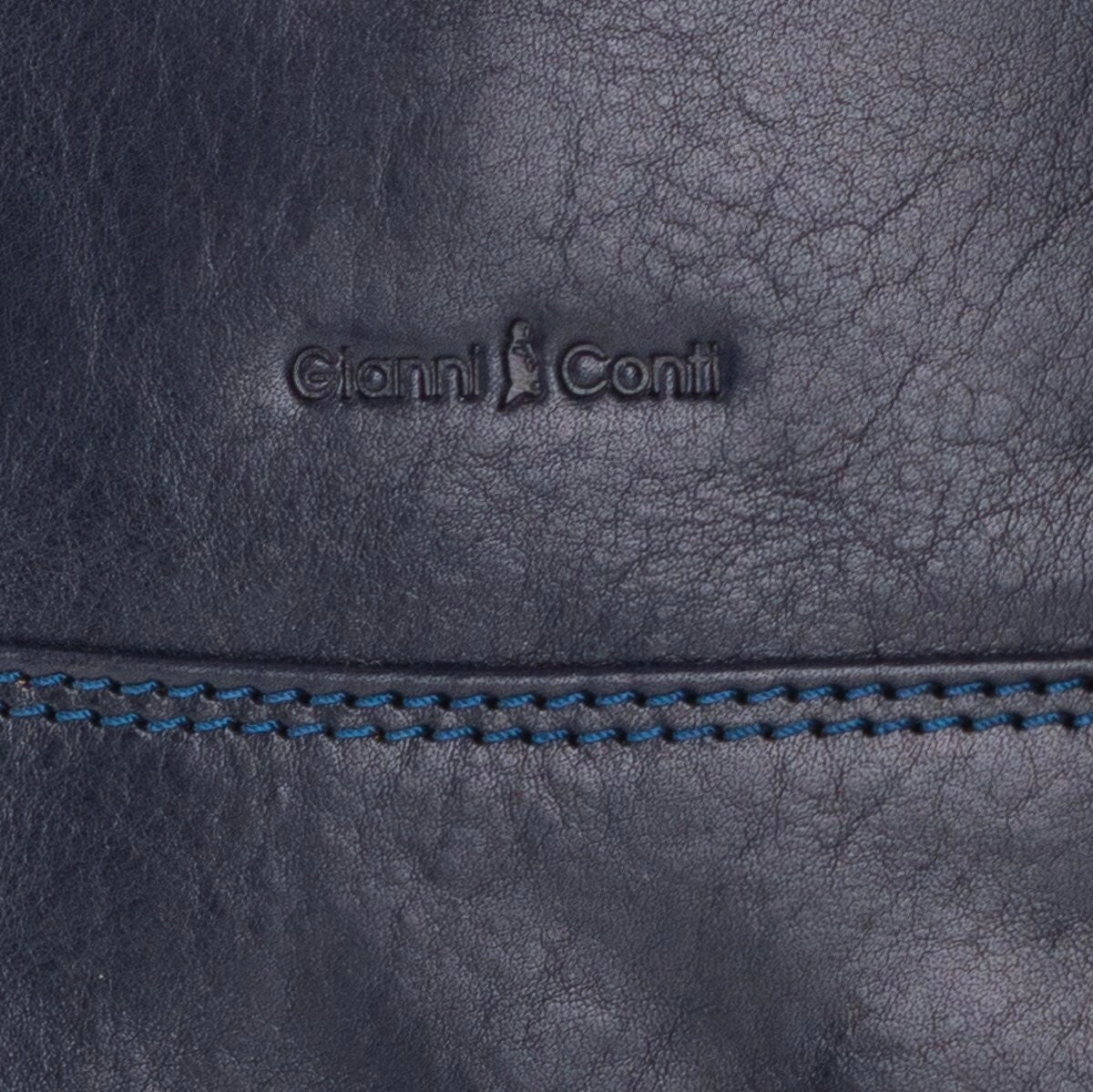 Close-up of a dark blue leather handbag with 'Gianni Conti' branding.