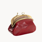 Red leather purse with gold clasp on a white background