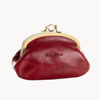 Red leather purse with gold clasp on a white background