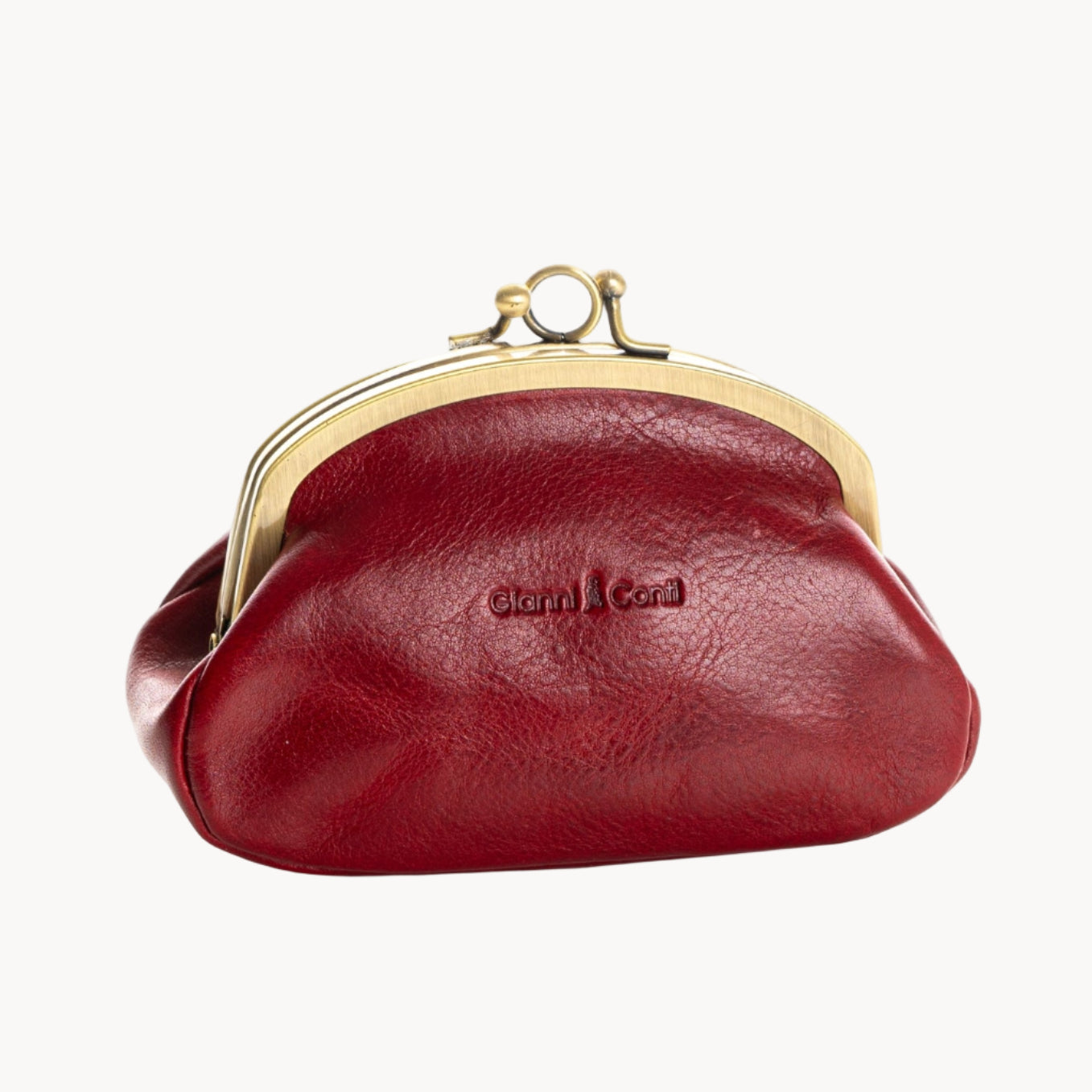 Red leather purse with gold clasp on a white background
