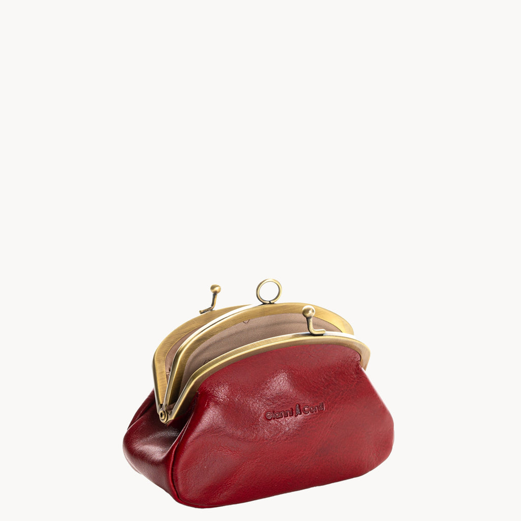Red leather coin purse with gold clip clasp on a white background