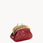 Red leather coin purse with gold clip clasp on a white background