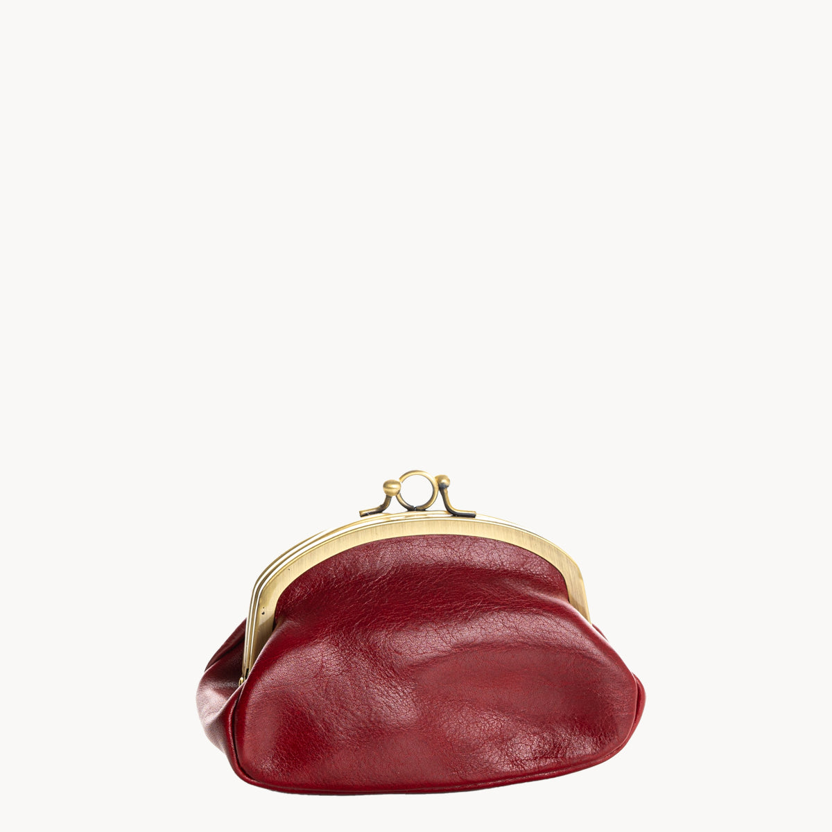 Red leather coin purse with gold clip clasp on a white background