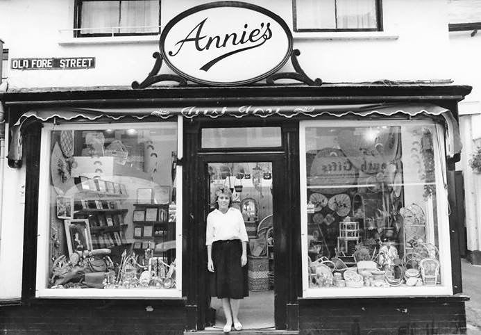 Woman standing in front of 'Annie's' store with a vintage look