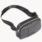 Black leather waist bag with a gold zipper on a white background
