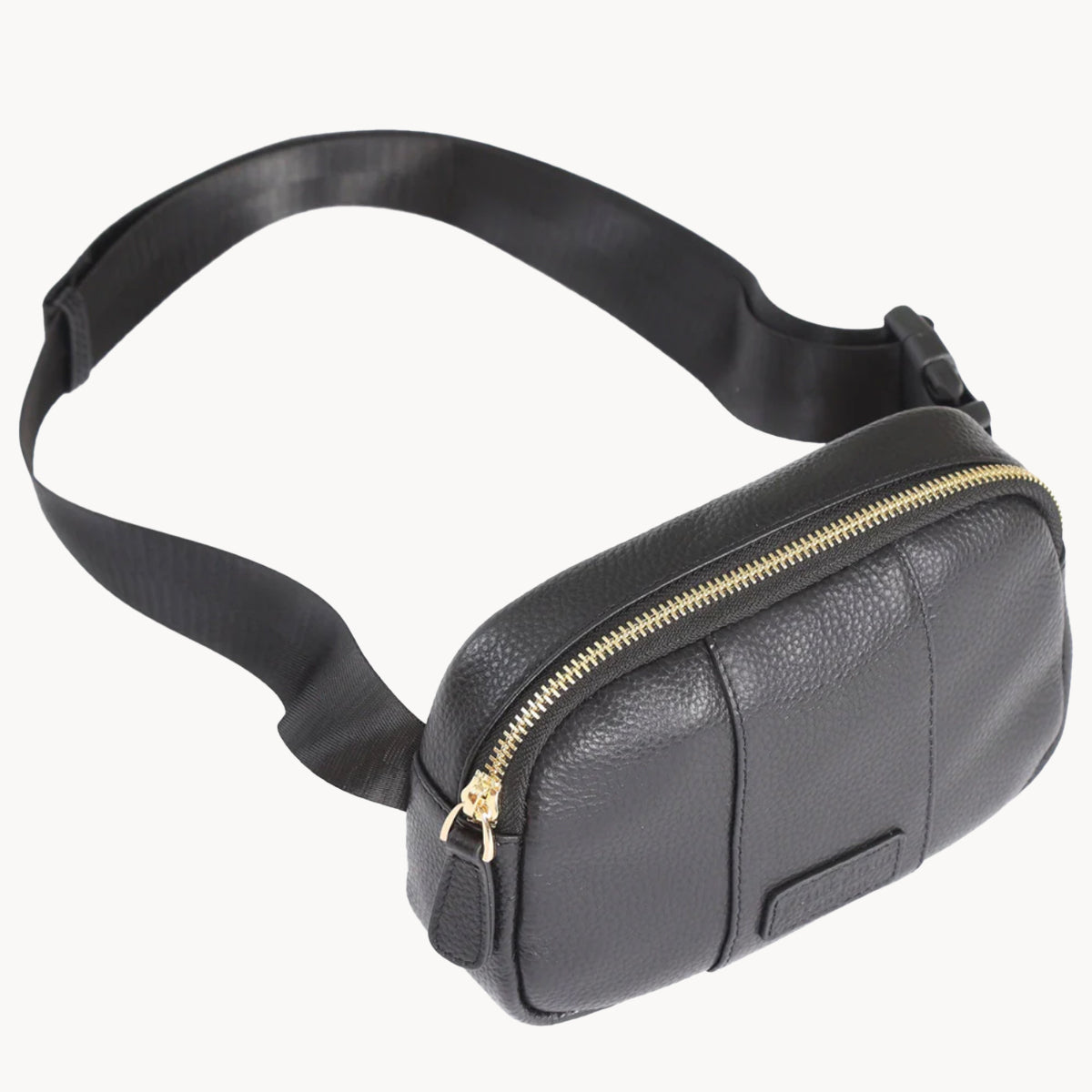 Black leather waist bag with a gold zipper on a white background