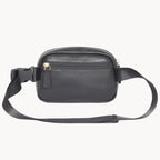 Black leather waist bag with a strap on a white background