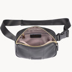 Black waist bag with a gold zipper on a white background