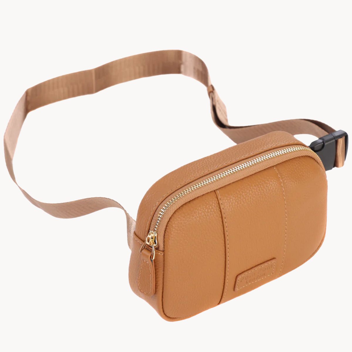 Tan leather waist bag with a strap on a white background