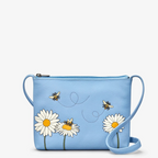 Blue handbag with floral designs and bee illustrations on a white background